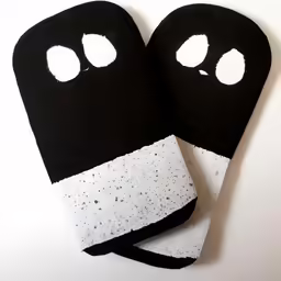 two black and white hand mitts that are folded up