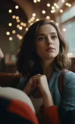 a woman with her hand on her shoulder