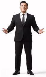 man in a suit smiling and posing with his hands out