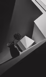 a vase with an object is sitting in a room