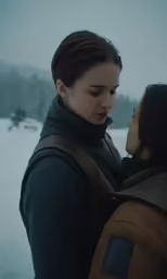 the two girls are hugging in the snow