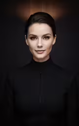 a woman with black hair is posing for a studio shot