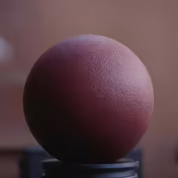 an orange is resting on a black stand