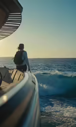a person on a boat overlooking the ocean