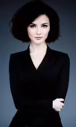 the woman is posing for the camera and wearing a suit