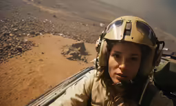 a female in a military outfit and helmet in an airplane