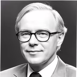 a man in a suit and tie smiling