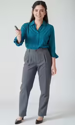 a women standing with a cell phone up to her ear