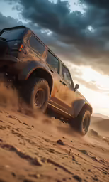 a jeep with big tires is driving down the dirt road