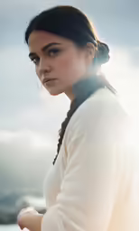 woman wearing white sweater looking away from camera