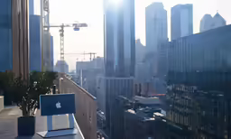 view from a roof of an office building with the sun behind