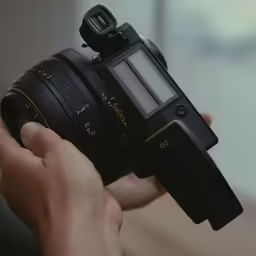 someone is holding their camera in their hand