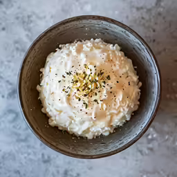 white food in a bowl on a white table