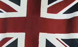 a red white and blue flag flying in the air