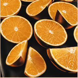 a close up of many oranges and slices cut in half