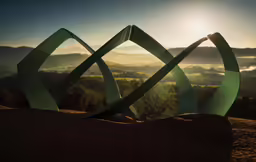 an abstract sculpture sits on top of a large rock