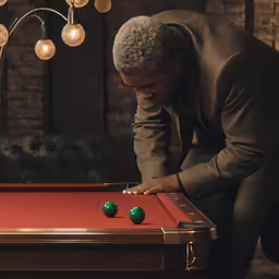 an older man leaning over a pool table