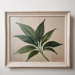 a painting on a white wall with green leaves