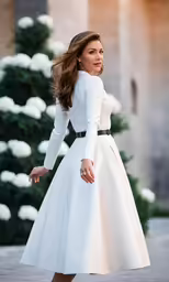 a beautiful woman in white dress outside a building