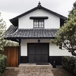 a white and black house with an overhang