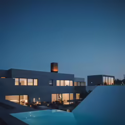 an ultra - modern house that is very lit up at night