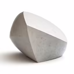 an cement object sitting in the middle of a white surface