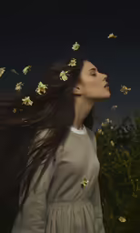 a girl standing in the middle of a field of flowers