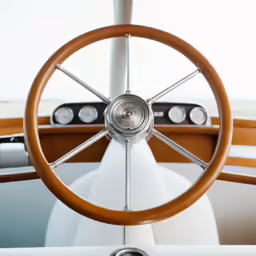 steering wheel and wooden spokes on a motor yacht