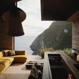 a view from inside a modern, open air living area overlooking the ocean