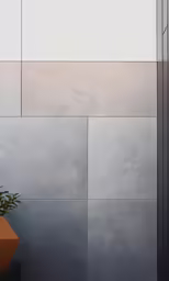 a large wall with a plant in a pot