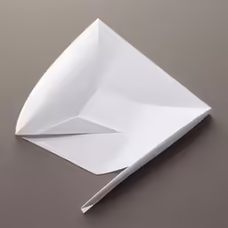 a white paper origami folded up to the top on the surface