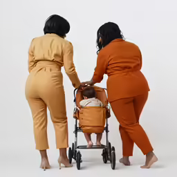 three women and a baby in oranges and browns