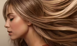 a woman with long blonde hair and light highlights