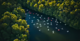 an aerial view shows a small group of planes in a line flying over trees