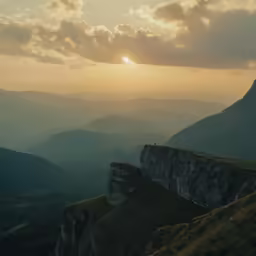 a mountain range is seen during the sun set