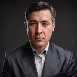 a man in grey jacket and white shirt