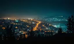 a town with mountains lit up in the background