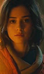a woman with brown hair and a jacket