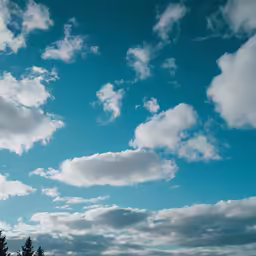 a beautiful sky with clouds and a plane flying in the air
