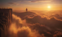 there is a man standing on the edge of a cliff with clouds rolling around
