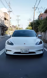 a white car is shown driving down the street