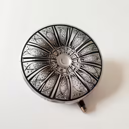 a decorative object on a white surface with a black and white pattern