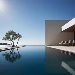 a beautiful pool overlooking the ocean with chaise lounges