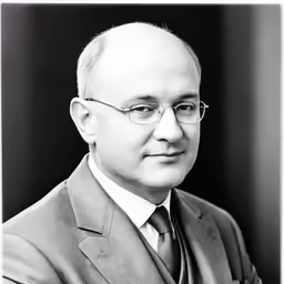 an old photograph of a man in a suit and tie