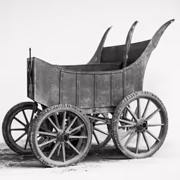 a small wooden carriage with two large wheels