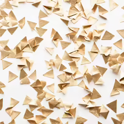 small gold triangles scattered next to a black background