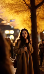 woman in brown trench coat walking on sidewalk