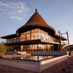 large curved house with water pool and pool side walk