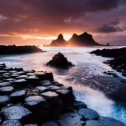 the setting sun shines down over the ocean