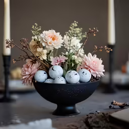 flowers, eggs and candles in a vase on the table